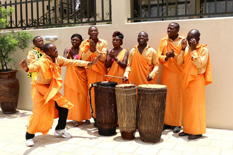 Even the dancers at a sweetpotato event color coordinate to the OFSP brand. Music and drama are often used to spread the message about OFSP. Photo by Sara Quinn/CIP