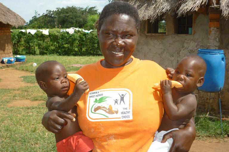 T-shirts such as the one worn by this caregiver in Malawi serve as powerful reminders to other mothers of the benefits of OFSP.  Photo by Erna Abidin/CIP